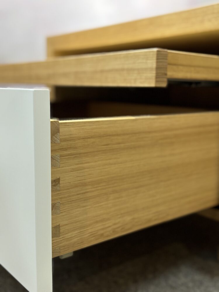 Adelaide, South Australian made oak timber bedside table with drawer and hidden shelf. Side view of drawer