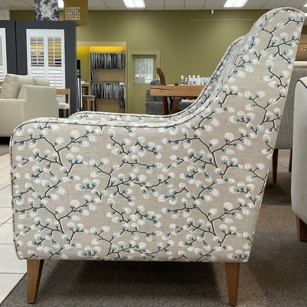 Molmic, Melbourne made fully pattern upholstered occasional chair with timber legs. View of side