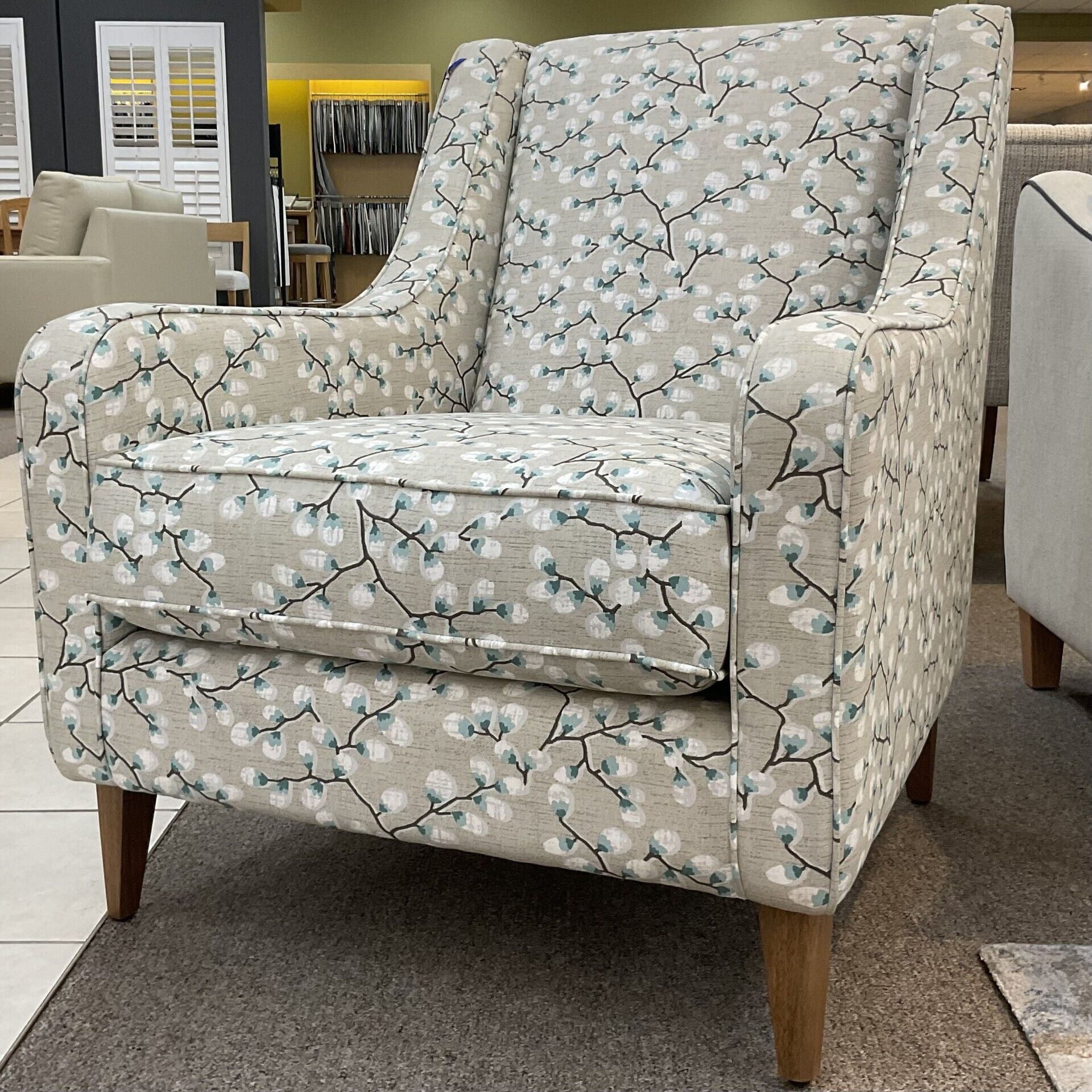 Molmic, Melbourne made fully pattern upholstered occasional chair with timber legs. View of side angle