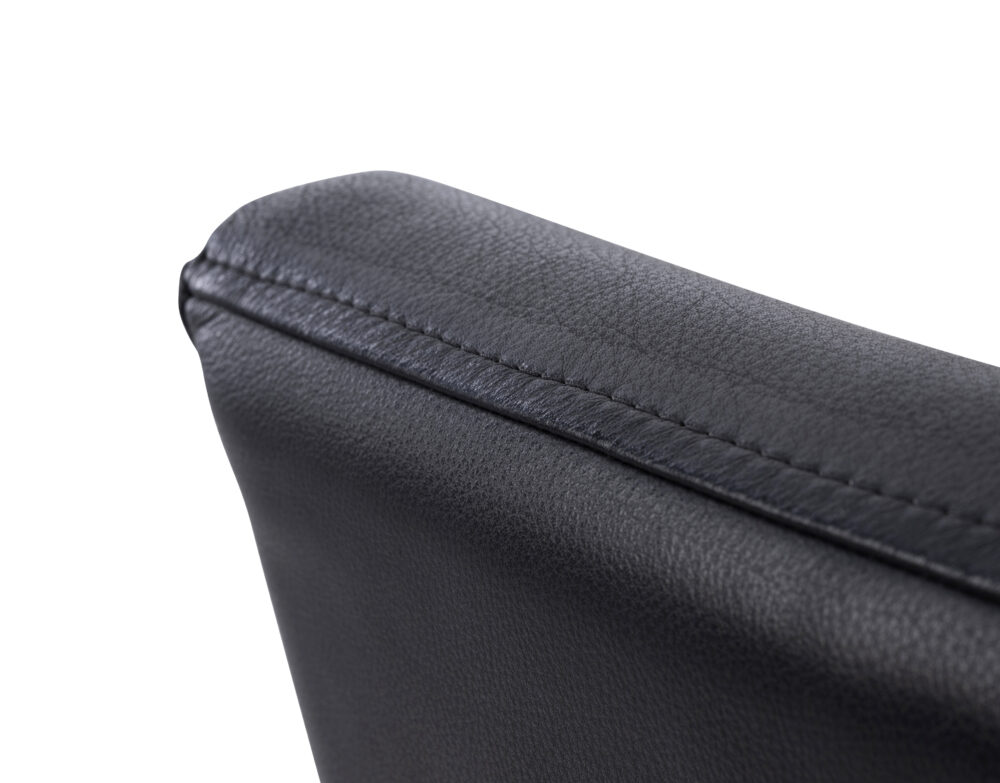 Adelaide, South Australian made solid timber Leone Low Back premium dining chair upholstered in black leather, view of top detail.