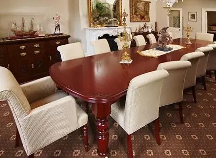 classic mahogany large dining table with white upholstered chairs